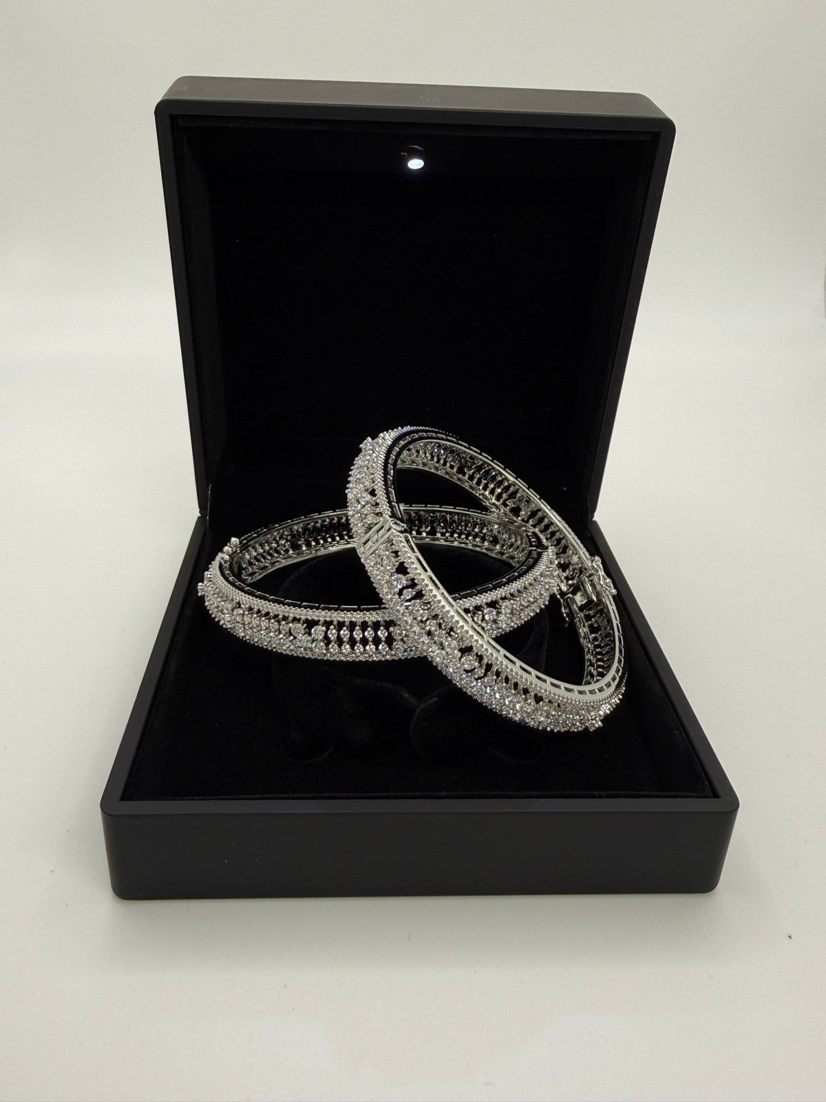 Silver-tone cubic zirconia statement bangle pair, close-up detail
