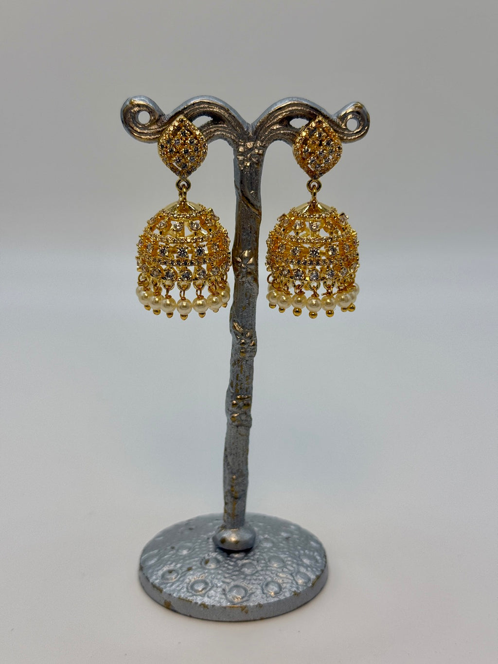 Gold-plated cubic zirconia jhumka earrings, close-up detail