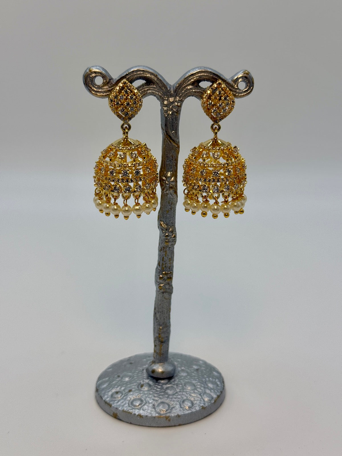 Gold-plated cubic zirconia jhumka earrings, close-up detail