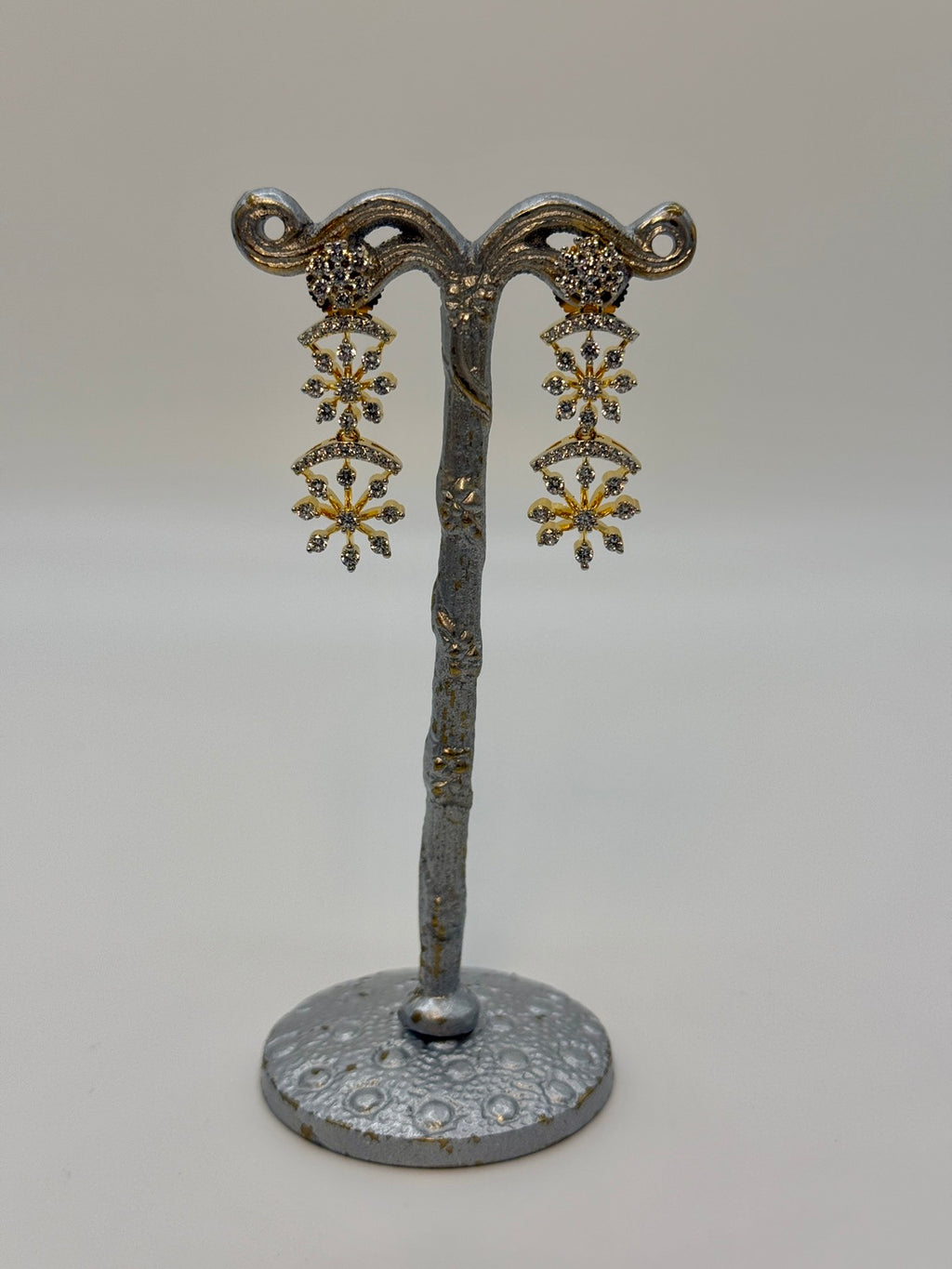 Gold-plated cubic zirconia snowflake drop earrings, close-up detail