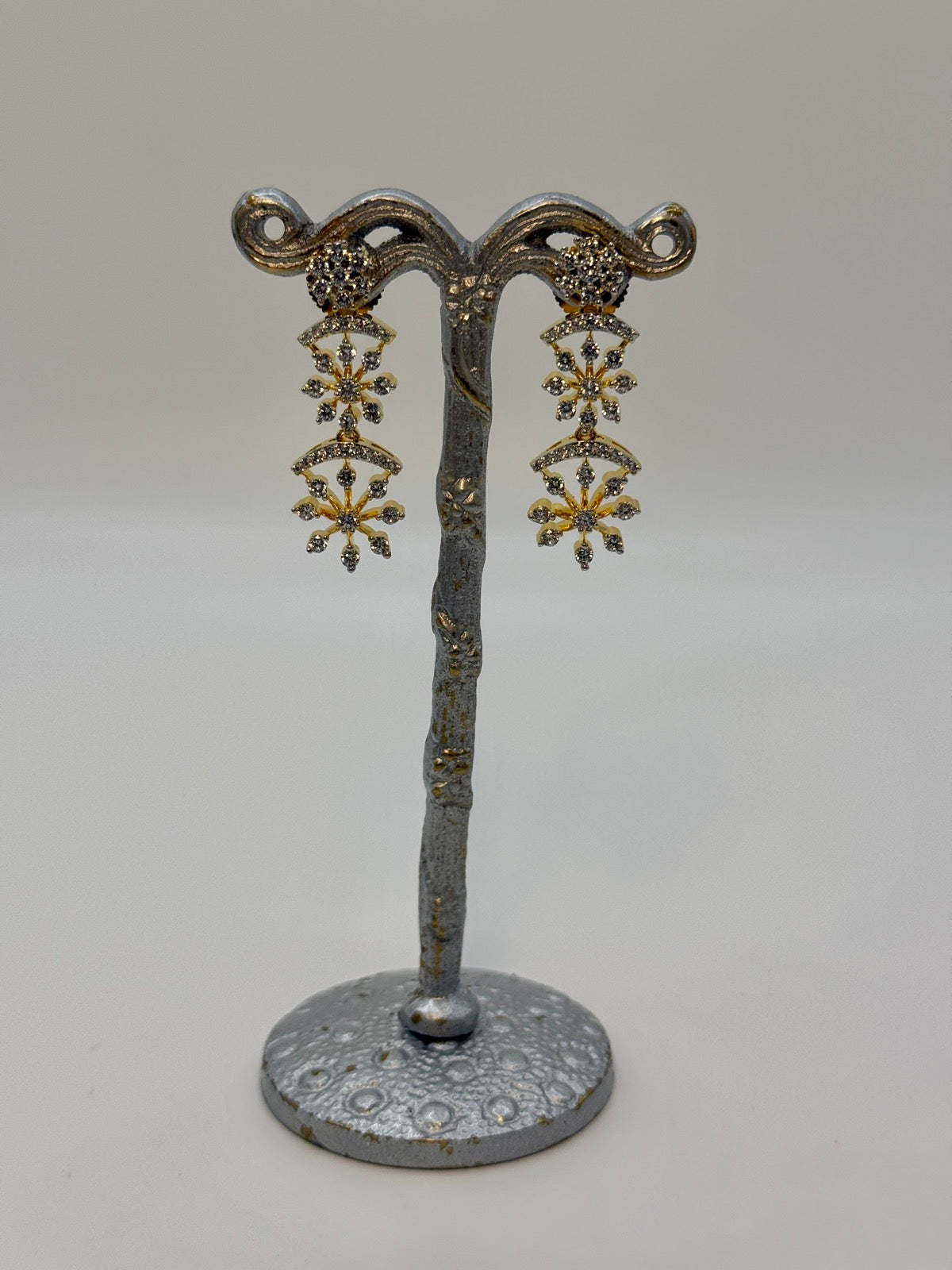 Gold-plated cubic zirconia snowflake drop earrings, close-up detail