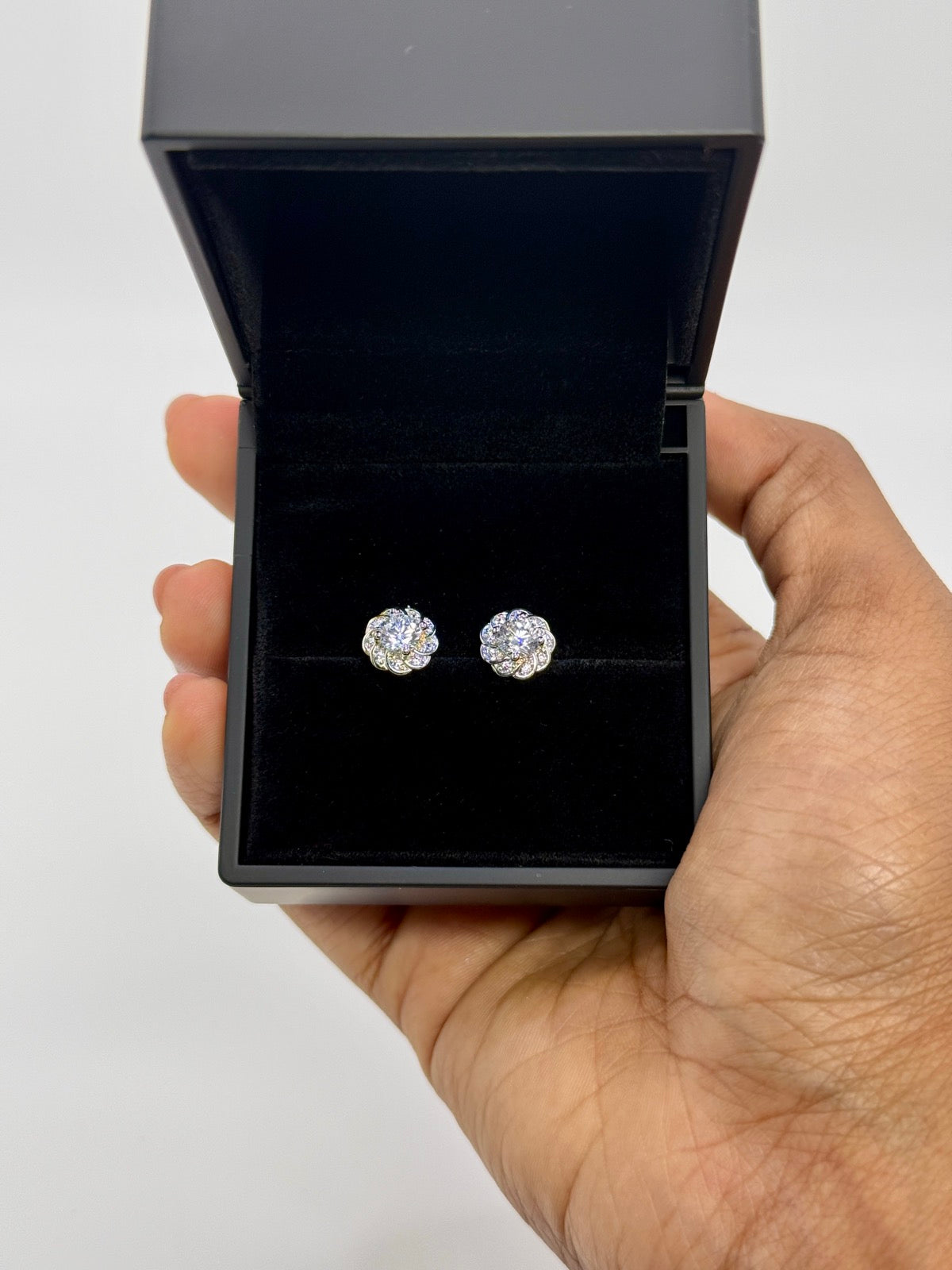 Silver-tone cubic zirconia floral stud earrings, close-up detail