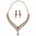 Layered gold-plated cubic zirconia necklace and earring set in blush pink, front view