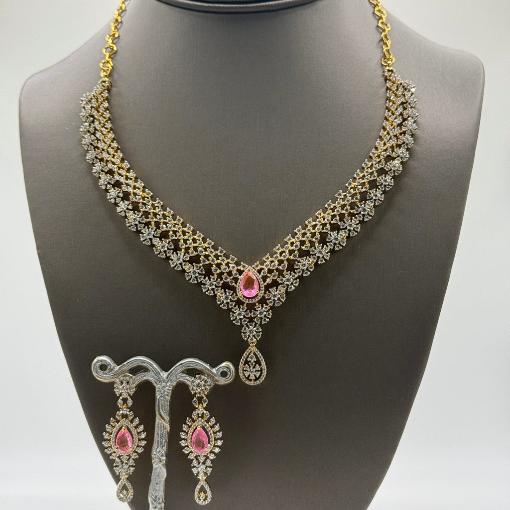 Layered gold-plated cubic zirconia necklace and earring set in blush pink, close-up detail