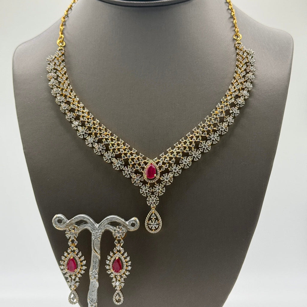Layered gold-plated cubic zirconia necklace and earring set in ruby red, close-up detail