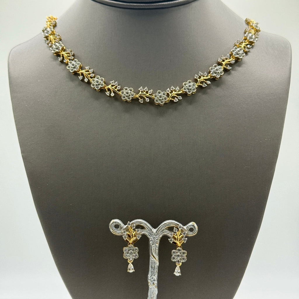 Delicate gold-plated cubic zirconia floral necklace and earring set, close-up detail
