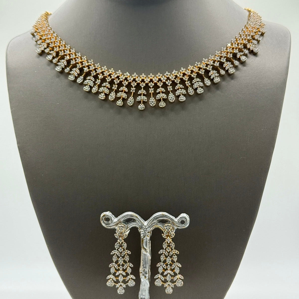 Gold-plated cubic zirconia teardrop necklace and earring set, close-up detail